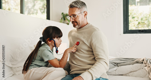 Foto Child, playing and stethoscope with father at house as pretend doctor, assessment and bonding