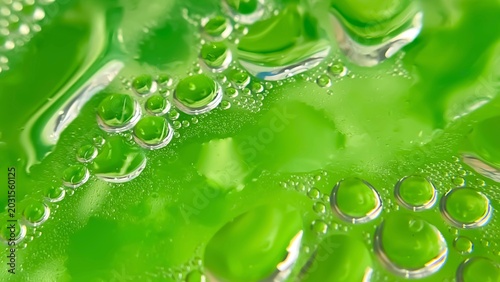 Slika na platnu An abstract surface with water droplets on a green background and smooth liquid shapes