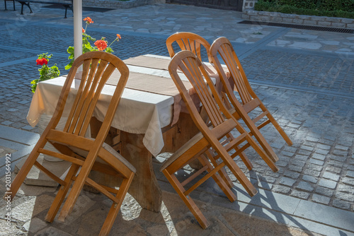 Table and chairs on the street. Street cafe.