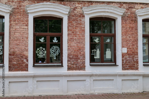 Quadro su tela Red brick building facade with two windows and white window sills