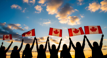 Canada day celebration silhouette people waving canadian flags at sunset
