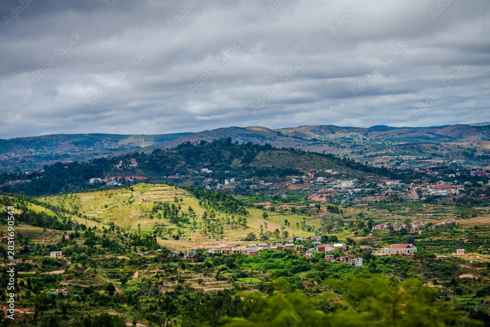 Fototapeta premium Hilly landscape with rural houses and agricultural terraces on the outskirts of Antananarivo