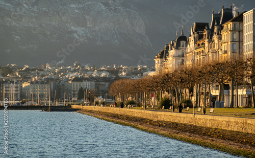 Geneva lake promenade with historic buildings and mountains