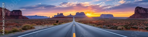 Empty Desert Highway Toward Monument Valley At Sunset