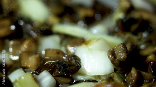 Delicious beef and mushroom stew with fresh onions cooking in a pan