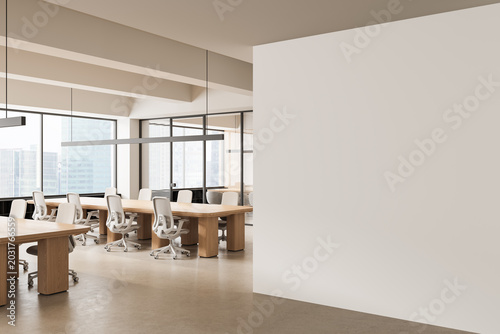 Quadro su tela Minimalist open office interior featuring wooden desks, white chairs and a large empty wall for creative mockup poster concept display