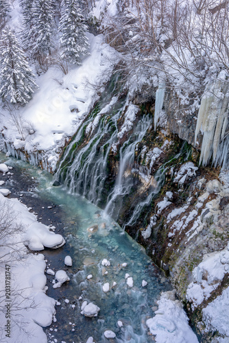 The Hokkaido Shirahige waterfall with snow covering it in winter season