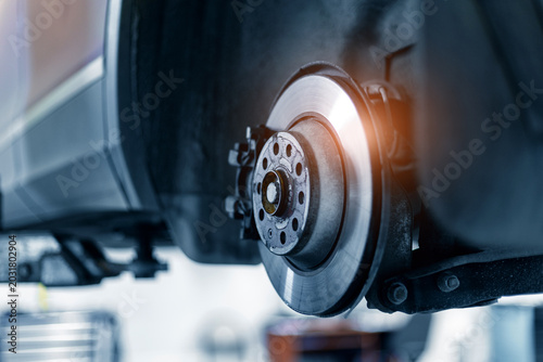 Schilderij op canvas Closeup of steel brake disc in car service