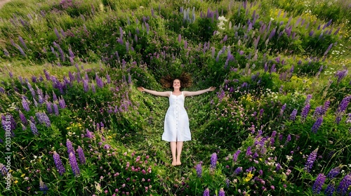 Woman lying in a field of wildflowers