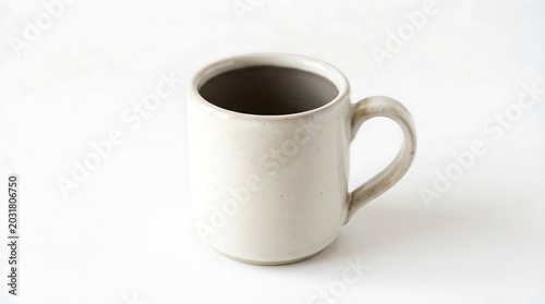 Simple ceramic mug with a smooth glazed finish and a sturdy handle stands alone in this bright studio photograph capturing the minimalist aesthetic of a classic kitchen drink vessel today.
