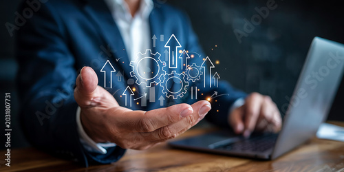Businessman holding gears and upward arrows, symbolizing growth