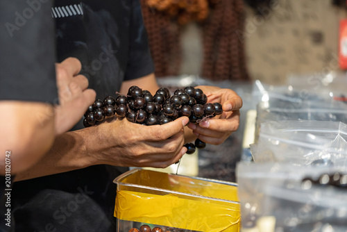 Photos Antique jewelry store owner showing ebony bracelet to customer
