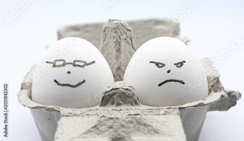 Fotografie Egg photo. Concept of expesive egg prices. Happy and angry faces.