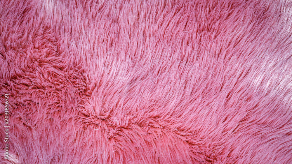 Fototapeta premium Soft pink furry texture close up showing the detailed strands and patterns of the fabric in daylight