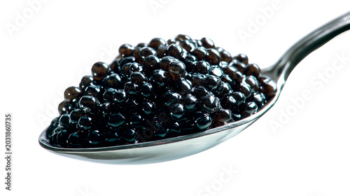 Close-up of black sturgeon caviar balls on a polished metal spoon, against a white background
