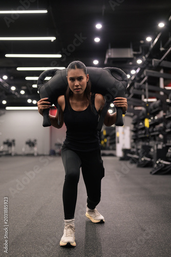 Asian Thai Isan Woman Doing Lunges with Bulgarian Bag at Gym