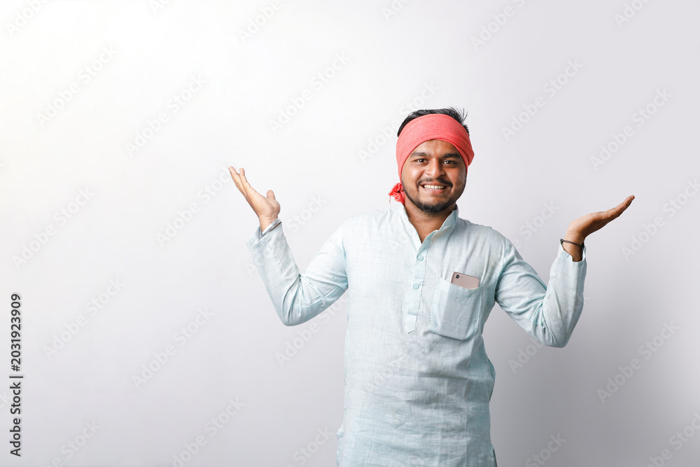Fototapeta premium young indian farmer showing hand gesture standing on white background