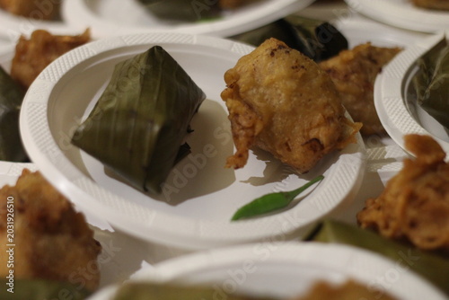 Photos Close-up of traditional Indonesian snacks lemper wrapped in banana leaf and frie