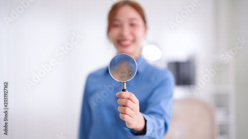 Asian business women holding magnifying glass showing search analysis research concept professional businesswoman investigating marketing data office workplace