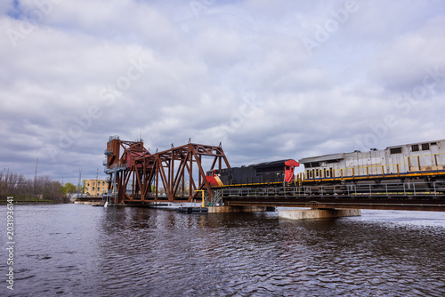 Canvas Print A train crossing a drawbridge over a river.