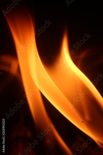Close Up of Firewood Burning with Golden Flames in a Traditional Stove