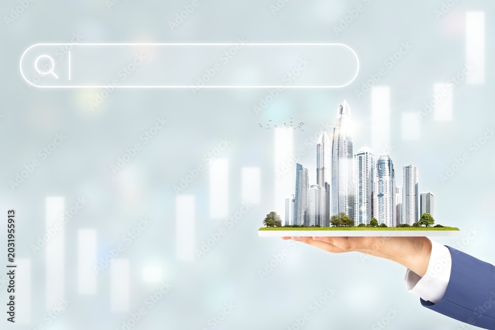 Fototapeta premium Business hand holding futuristic city skyline with search bar