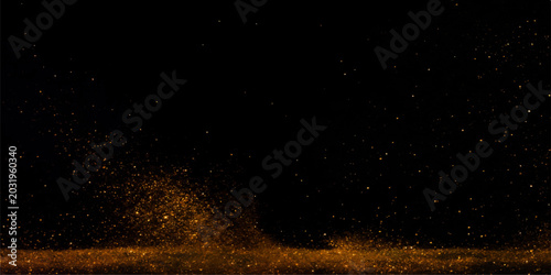 Slika na platnu Golden dust particles swirl and explode in a dramatic, abstract explosion against a stark black background, creating a mesmerizing visual spectacle