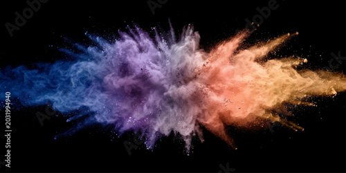 Quadro su tela Vibrant explosion of colorful powder pigments erupting against a stark black background, creating a dynamic and artistic visual display of abstract energy