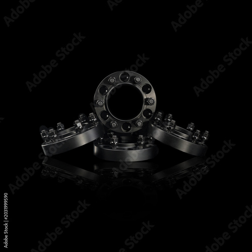 Photos Black anodized aluminum wheel spacers on black background, hubcentric car wheel