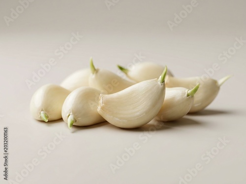 Fresh white radishes with green sprouts on light neutral background.