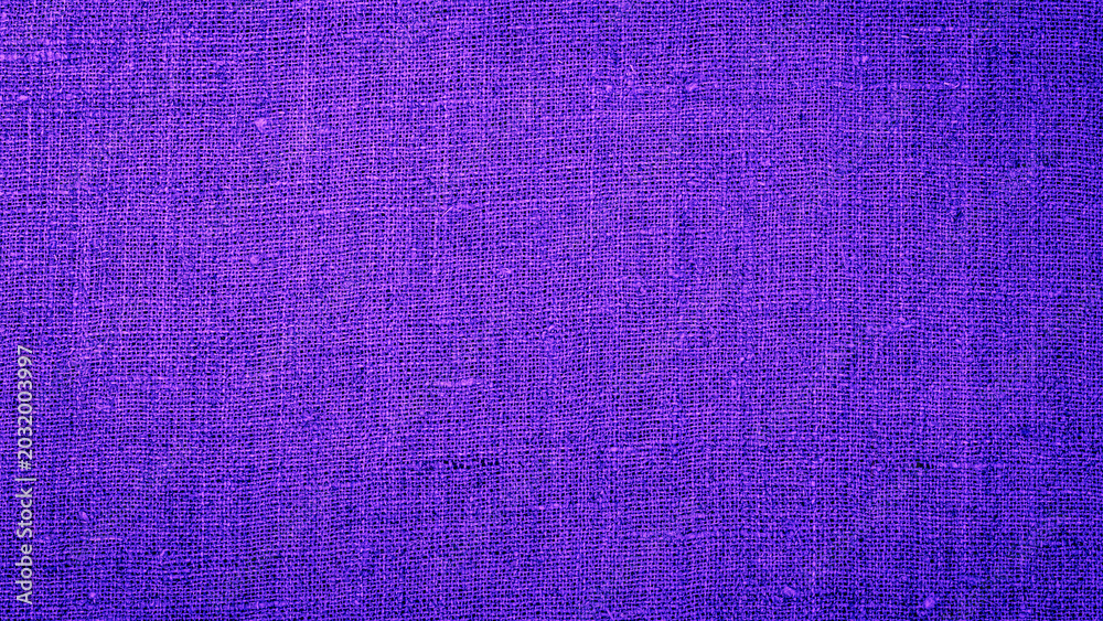 Fototapeta premium Purple fabric texture shows its detailed weave and strong color in bright light during the day for textile design use