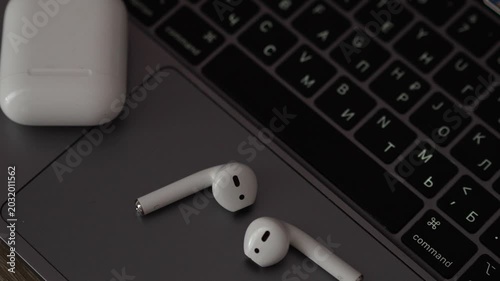 White plastic wireless headphones on the table