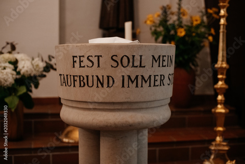 Photos Stone baptismal font with german inscription in church
