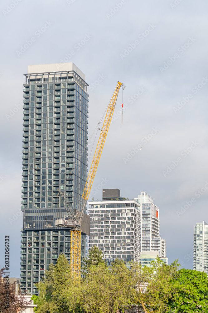 Fototapeta premium Urban High Rise Tower and Construction Crane in Vancouver Skyline
