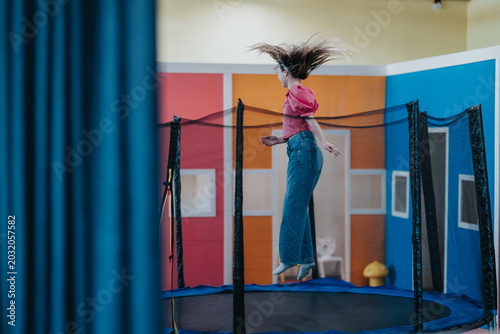 Cuadro en lienzo Two friends jump on an indoor trampoline, hair flying as they bounce mid-air