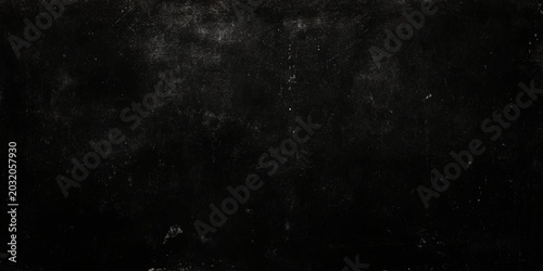 Slika na platnu Dark textured surface with scratches and marks on a worn black background