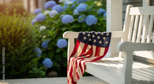 American flag draped over white wooden chair with blooming hydrangeas outside