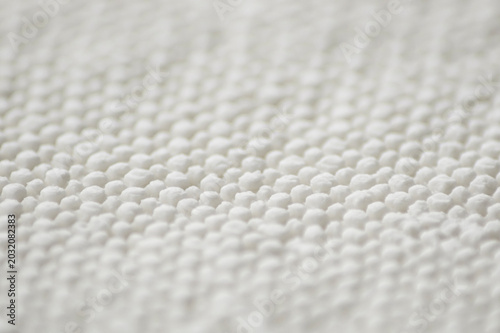 Selective focus shot of cloth pattern on white cheese 