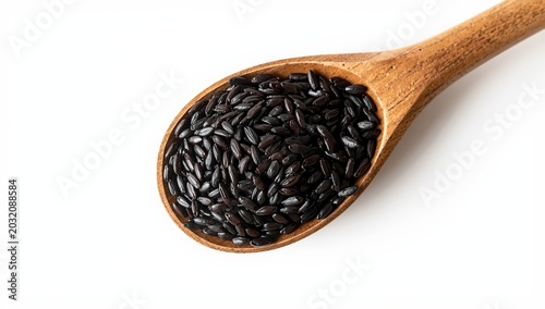 Close-up of black wild rice in a wooden spoon on a white background.