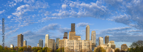 Photography A wide panoramic skyline view of high rise apartment buildings and residential c
