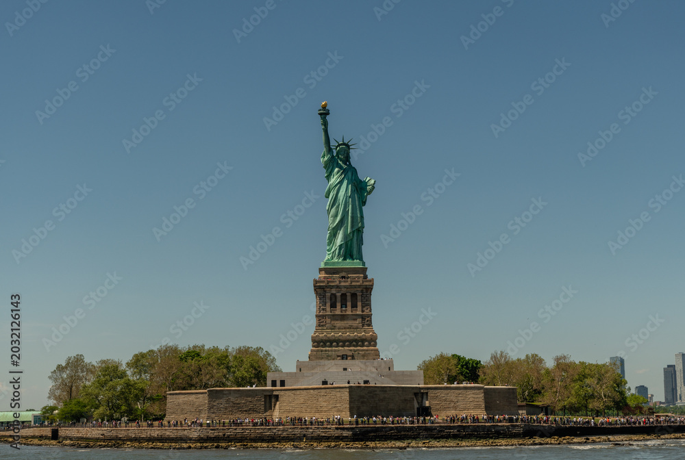 Fototapeta premium Statue of liberty on a clear summer day viewed from a boat, New York City