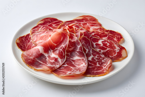Premium Italian Coppa and Capicola Slices Artfully Arranged on a Full White Plate for Culinary Delight