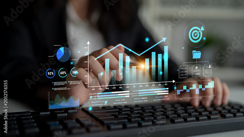 Foto Business Professional Analyzing Data Visualizations and Interactive Graphs on Keyboard in a Modern Office Environment Haptic