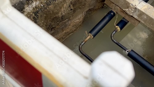 Open utility pipes at a construction site in water