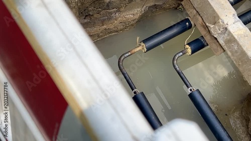 Open utility pipes at a construction site in water
