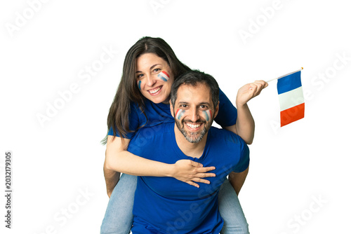 French couple cheering national team with flag and face paint