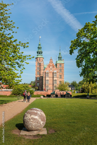 Rosenborg Castle in Copenhagen, Denmark. Historic renaissance palace in the King's Garden on a bright sunny spring day with green trees and blue sky.