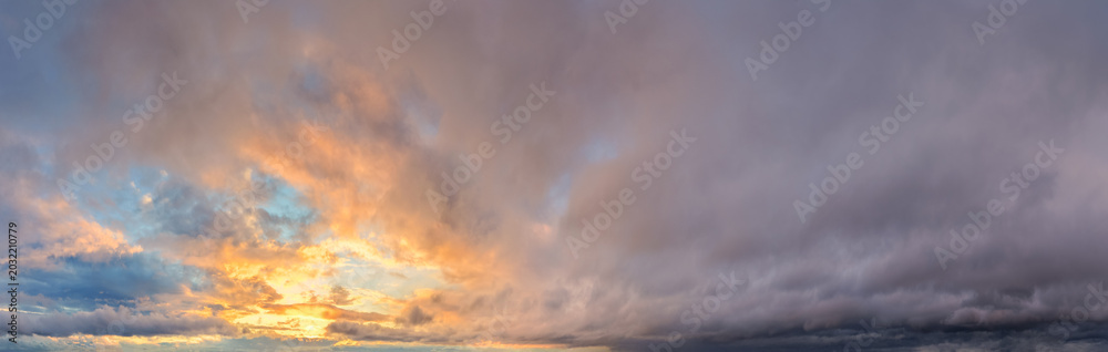 Obraz premium Dramatic Sunset Cloudscape Over A Vast Sky With Colorful Evening Clouds And Soft Light