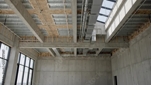 Modern Industrial Building Interior with Expansive Concrete Walls and Large Windows