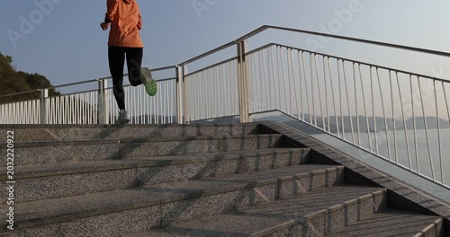 Fitness sports woman runner running on seaside trail, slow motion